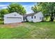 Exterior of home featuring white siding, green lawn, and detached garage at 6580 N Us Highway 31, Whiteland, IN 46184