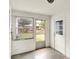 Sunroom with large windows, white walls, and screened door to outdoors at 6580 N Us Highway 31, Whiteland, IN 46184