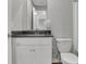 Modern bathroom features a white vanity with dark countertop and a stylish decorative accent at 6675 Halsey St, Zionsville, IN 46077