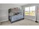 Cozy bedroom features a bunk bed with stylish plaid bedding and a view of the outdoors at 6675 Halsey St, Zionsville, IN 46077