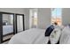 Bright bedroom features matching mirrors and a plush bed with luxury white linens and blue accents at 6675 Halsey St, Zionsville, IN 46077