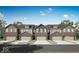 New brick townhomes featuring well-manicured lawns, two-car garages, and attractive architectural details at 6675 Halsey St, Zionsville, IN 46077