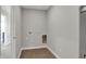 Empty laundry room with tile floor and wall hook ups ready for appliances at 6675 Halsey St, Zionsville, IN 46077