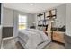 Cozy bedroom featuring a comfortable bed, stylish decor, and a large window with scenic views at 6706 Halsey St, Zionsville, IN 46077