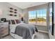Bright bedroom with large window view, complemented by neutral gray and tan tones at 6706 Halsey St, Zionsville, IN 46077