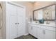 Bathroom featuring double sinks, white cabinetry, and a framed mirror at 7595 Bluegill Dr, Noblesville, IN 46062