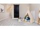 Cozy bonus room decorated with a teepee, ladder, and storage baskets at 7595 Bluegill Dr, Noblesville, IN 46062