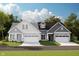 Charming home exterior with stone accents, gray siding, and a two-car garage at 7595 Bluegill Dr, Noblesville, IN 46062