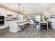 Modern kitchen with an island open to a large living room at 7595 Bluegill Dr, Noblesville, IN 46062