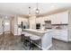 Modern kitchen with stainless steel appliances, gray wood floors and island with seating at 7595 Bluegill Dr, Noblesville, IN 46062