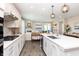 Modern open concept kitchen with island seating and stainless steel appliances at 7595 Bluegill Dr, Noblesville, IN 46062