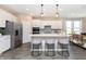 Modern white kitchen with stainless steel appliances and a large kitchen island at 7595 Bluegill Dr, Noblesville, IN 46062