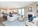 Bright living room with fireplace, large window, and open concept to the kitchen at 7595 Bluegill Dr, Noblesville, IN 46062