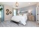 This primary bedroom has a decorative accent wall, beautiful furnishings, and neutral colors at 7595 Bluegill Dr, Noblesville, IN 46062