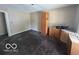 Spacious kitchen area with natural light, in need of renovations, with hardwood floors at 7607 E 46Th St, Indianapolis, IN 46226