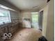 Kitchen interior in need of renovation, featuring an open layout and a window view at 7607 E 46Th St, Indianapolis, IN 46226
