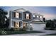 Charming two-story home featuring gray siding, brick accents, and an attached two-car garage at 7658 Allesley Dr, Avon, IN 46123