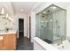 Bright bathroom with a glass-enclosed shower, double sinks, and modern lighting at 7775 N Meridian St, Indianapolis, IN 46260