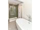 Modern bathroom featuring soaking tub, glass shower, and sleek fixtures at 7775 N Meridian St, Indianapolis, IN 46260