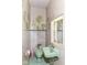 Retro bathroom featuring a green sink, toilet, and green leafy wallpaper, offering a vintage aesthetic at 7775 N Meridian St, Indianapolis, IN 46260