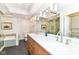 Bathroom featuring double vanity, modern lighting, separate tub, and glass-enclosed shower at 7775 N Meridian St, Indianapolis, IN 46260