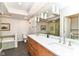 Well-lit bathroom featuring double vanity, modern fixtures, and a separate tub at 7775 N Meridian St, Indianapolis, IN 46260