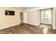 Bright bedroom featuring hardwood floors, natural light, and a modern mounted television at 7775 N Meridian St, Indianapolis, IN 46260
