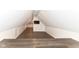 Finished attic bedroom space with hardwood floors and a mounted television at 7775 N Meridian St, Indianapolis, IN 46260