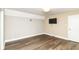 Cozy bedroom with laminate floors, neutral paint, and modern lighting fixture at 7775 N Meridian St, Indianapolis, IN 46260