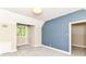 Bright bedroom featuring soft carpet, natural light from the window and a fresh blue accent wall at 7775 N Meridian St, Indianapolis, IN 46260