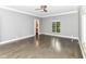Spacious bedroom featuring hardwood floors, a ceiling fan, and a window with a view at 7775 N Meridian St, Indianapolis, IN 46260