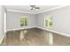 Bright bedroom with hardwood floors, two windows, and neutral wall color at 7775 N Meridian St, Indianapolis, IN 46260