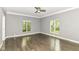 Bright bedroom with hardwood floors, crown molding, and plenty of natural light through multiple windows at 7775 N Meridian St, Indianapolis, IN 46260