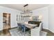 Charming dining room features stylish chairs, modern chandelier, and a view to the kitchen at 7775 N Meridian St, Indianapolis, IN 46260