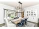 Charming dining room features stylish chairs, modern chandelier, and a view to the yard at 7775 N Meridian St, Indianapolis, IN 46260
