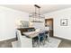 Charming dining room features stylish chairs, modern chandelier, and a view to the hall at 7775 N Meridian St, Indianapolis, IN 46260