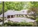 Beautiful home features a large brick driveway and a well manicured lawn surrounded by mature trees at 7775 N Meridian St, Indianapolis, IN 46260