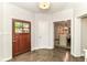 Inviting foyer with hardwood floors, a paneled front door, and neutral walls at 7775 N Meridian St, Indianapolis, IN 46260