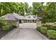Charming stone home with beautiful landscaping and a spacious driveway at 7775 N Meridian St, Indianapolis, IN 46260