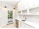 Kitchenette features marble countertops, white cabinets, stainless steel appliances and stylish lighting fixtures at 7775 N Meridian St, Indianapolis, IN 46260