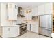 Modern kitchen features white cabinets, marble countertops, stainless steel appliances, and designer backsplash at 7775 N Meridian St, Indianapolis, IN 46260