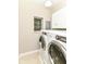 Bright laundry room featuring updated appliances and tile flooring at 7775 N Meridian St, Indianapolis, IN 46260