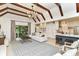 Open living room with hardwood floors, vaulted ceilings, fireplace, and large windows with seating at 7775 N Meridian St, Indianapolis, IN 46260