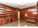 Private home office with hardwood floors, custom built-in shelving, and wood trim throughout at 7775 N Meridian St, Indianapolis, IN 46260
