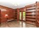 Elegant office with rich wood paneling, built-in bookshelves, and natural light from french doors at 7775 N Meridian St, Indianapolis, IN 46260