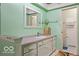 Traditional bathroom featuring a mirror over vanity and an entry to the toilet and shower area at 813 Boulder Rd, Indianapolis, IN 46217