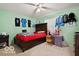 This bedroom has a bright ceiling fan and decorated walls at 813 Boulder Rd, Indianapolis, IN 46217