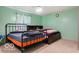 Bedroom features two beds, light green walls, and neutral carpet at 813 Boulder Rd, Indianapolis, IN 46217