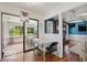 Cozy breakfast nook with sliding door access to sunroom, situated beside Gathering room with fireplace at 813 Boulder Rd, Indianapolis, IN 46217