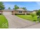 Charming brick ranch-style home features an attached two-car garage and a well-maintained front yard at 813 Boulder Rd, Indianapolis, IN 46217